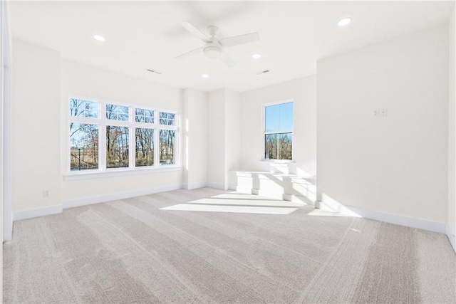 empty room featuring ceiling fan, baseboards, recessed lighting, and light colored carpet