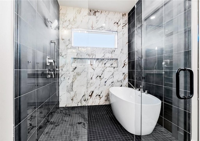 full bathroom featuring a freestanding tub, tile walls, and a stall shower