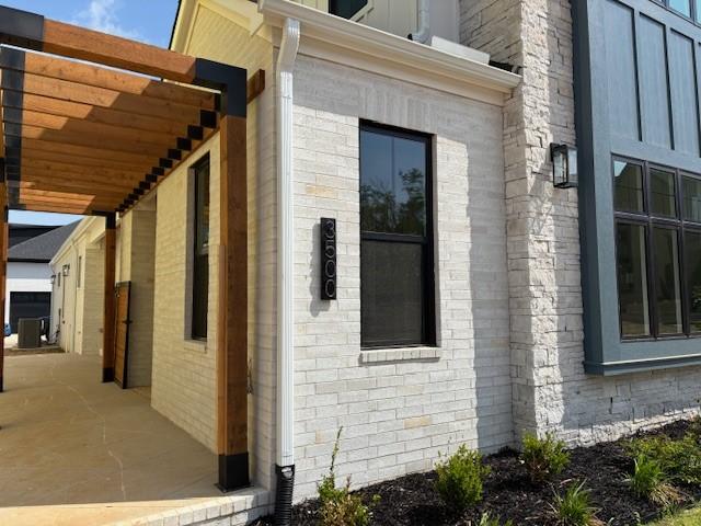 view of side of property featuring brick siding