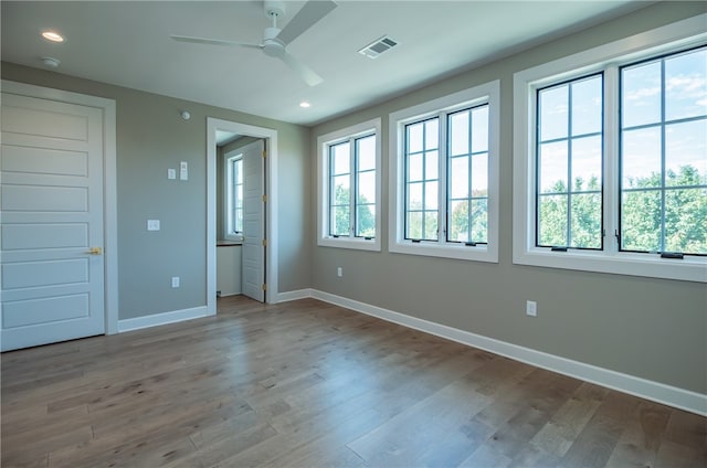 unfurnished bedroom featuring light hardwood / wood-style flooring and multiple windows