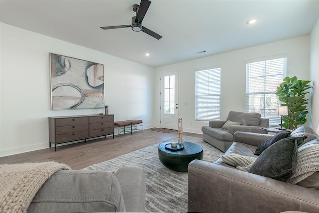 living room featuring hardwood / wood-style flooring and ceiling fan