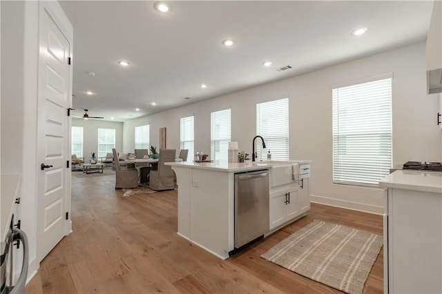 427 E Martin Luther King Jr Blvd, Fayetteville, AR 72701 - kitchen with appliances with stainless steel finishes, white cabinets, light wood-style flooring, recessed lighting, and light countertops