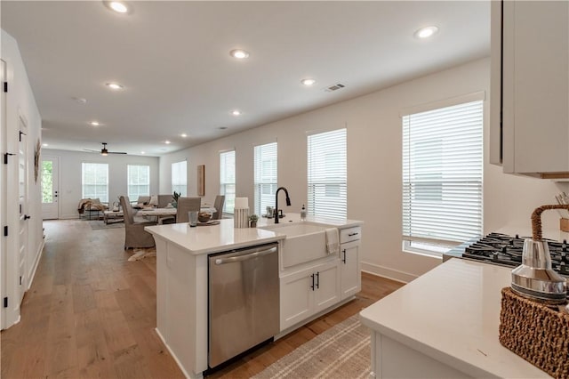 427 E Martin Luther King Jr Blvd, Fayetteville, AR 72701 - kitchen with appliances with stainless steel finishes, light wood-style flooring, white cabinets, recessed lighting, and light countertops