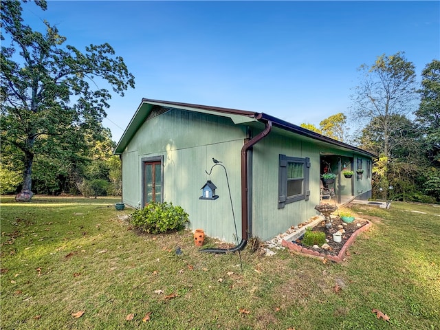 view of side of home featuring a yard