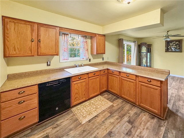 kitchen featuring black dishwasher, dark hardwood / wood-style floors, sink, kitchen peninsula, and ceiling fan