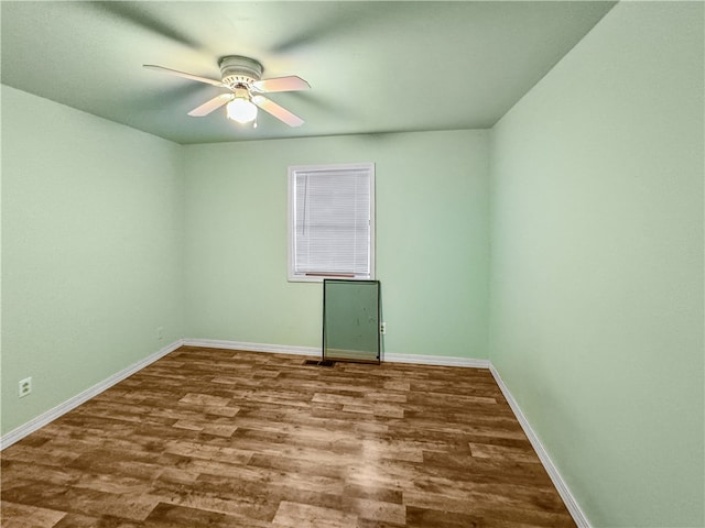 empty room featuring ceiling fan and hardwood / wood-style flooring