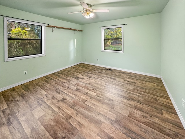 empty room featuring hardwood / wood-style floors and ceiling fan