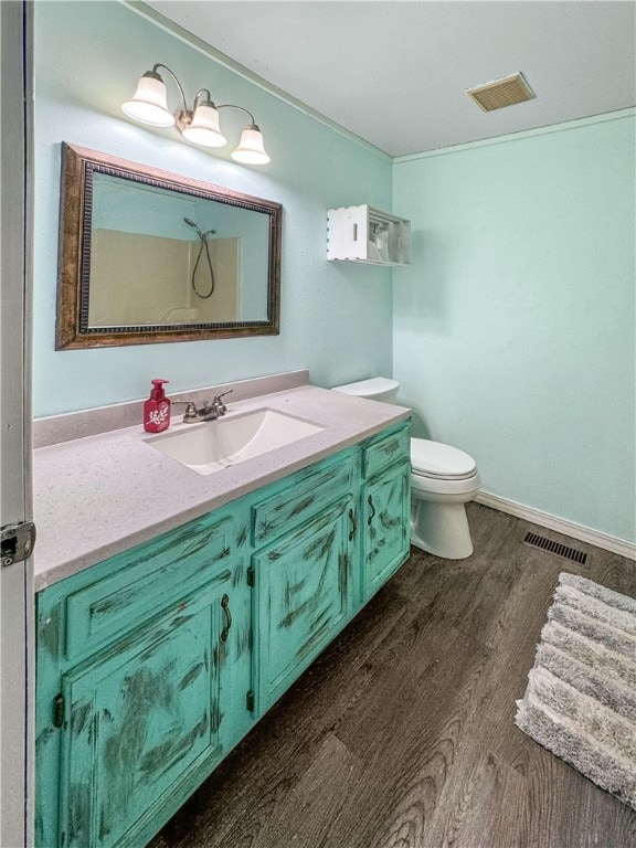 bathroom featuring hardwood / wood-style flooring, vanity, and toilet