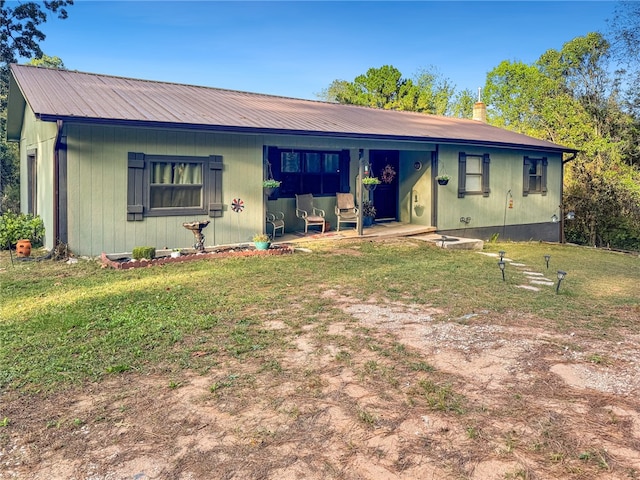 ranch-style home with a front lawn and a patio