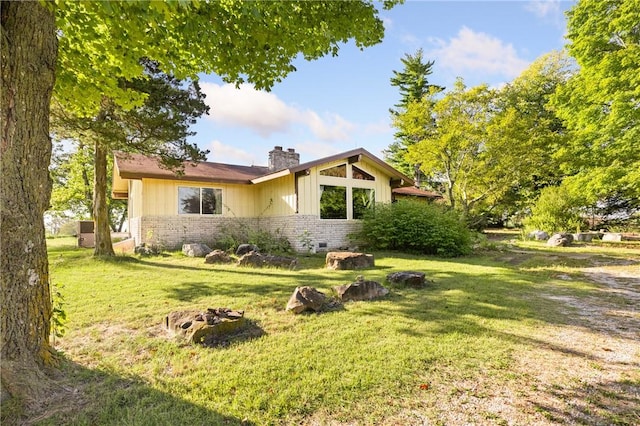 view of side of property with a lawn