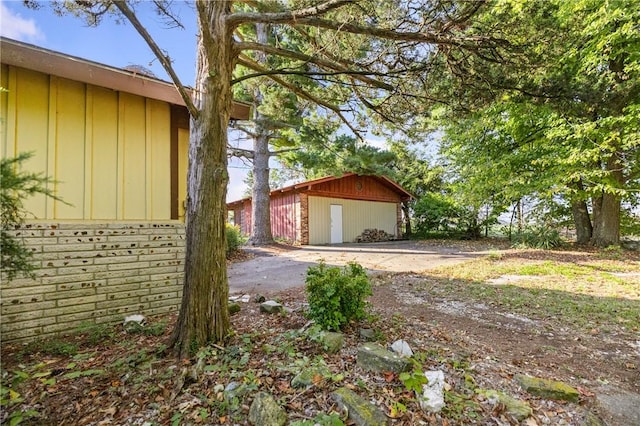 view of home's exterior featuring a garage and an outbuilding