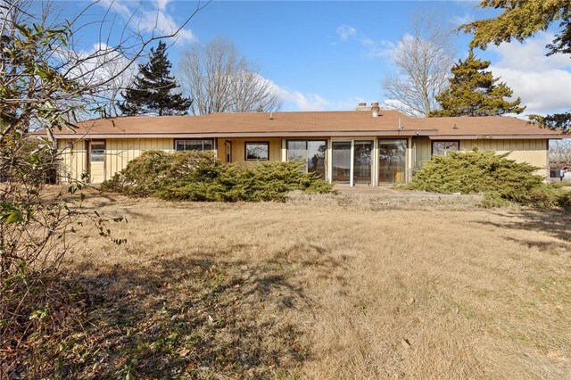 rear view of house with a lawn