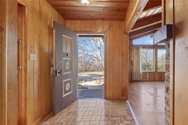 entryway with wooden walls and wood ceiling