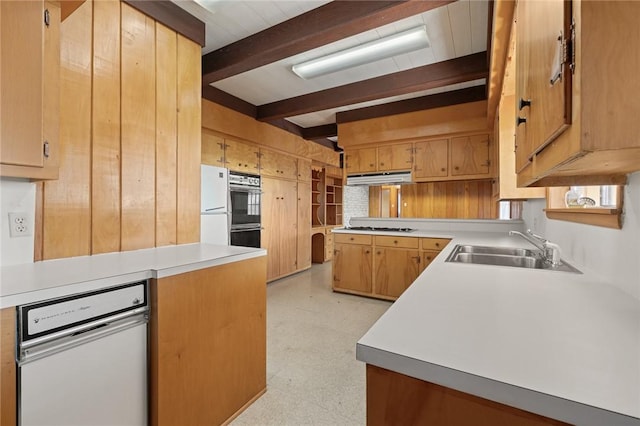 kitchen with kitchen peninsula, white appliances, wooden walls, sink, and beamed ceiling