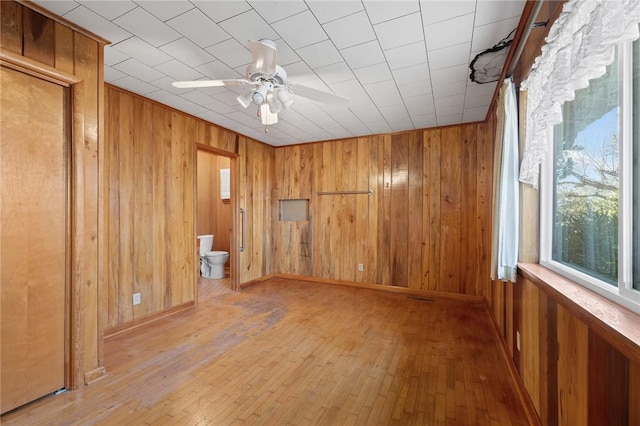 unfurnished room with ceiling fan and light wood-type flooring