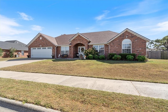 ranch-style house featuring driveway, an attached garage, a front lawn, and brick siding