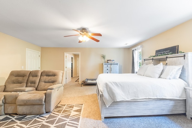 bedroom featuring ceiling fan and light carpet