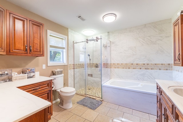 full bathroom featuring vanity, toilet, independent shower and bath, and tile patterned flooring