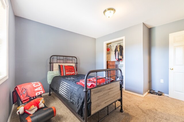 carpeted bedroom featuring a closet