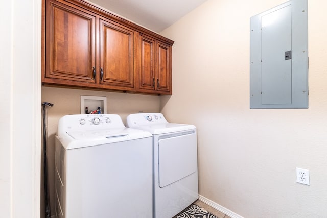 washroom with electric panel, washing machine and clothes dryer, and cabinets