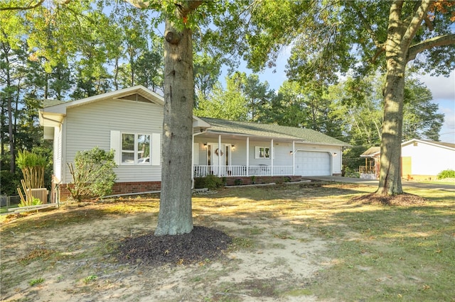 ranch-style home featuring a garage and covered porch