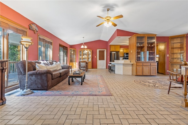 living room with plenty of natural light, vaulted ceiling, and ceiling fan