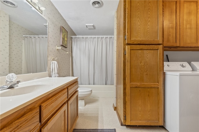 full bathroom featuring shower / tub combo with curtain, washing machine and clothes dryer, vanity, and toilet