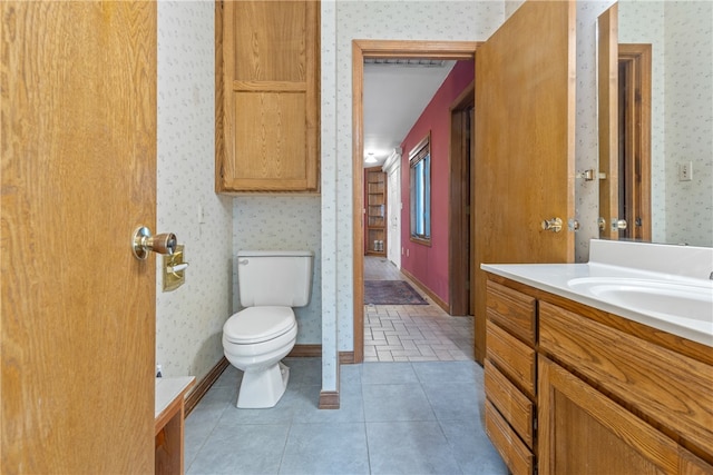 bathroom featuring tile patterned floors, vanity, and toilet