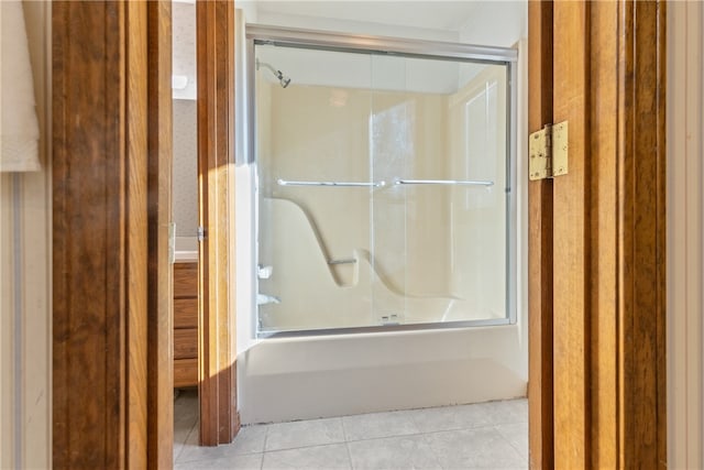 bathroom featuring combined bath / shower with glass door and tile patterned floors