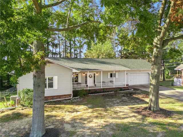 single story home with a garage and covered porch