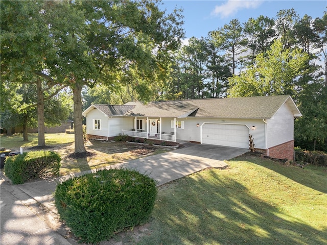 view of front of home featuring a garage, a porch, and a front lawn