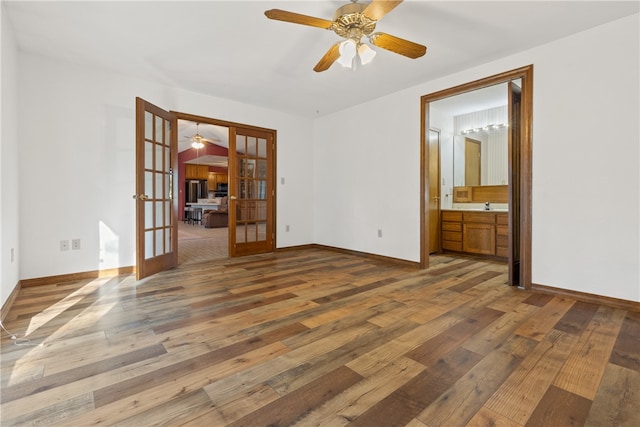 empty room with hardwood / wood-style floors, ceiling fan, and french doors