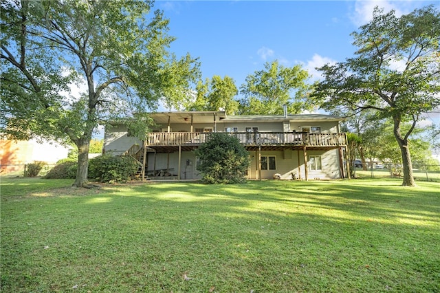 back of house featuring a deck and a lawn