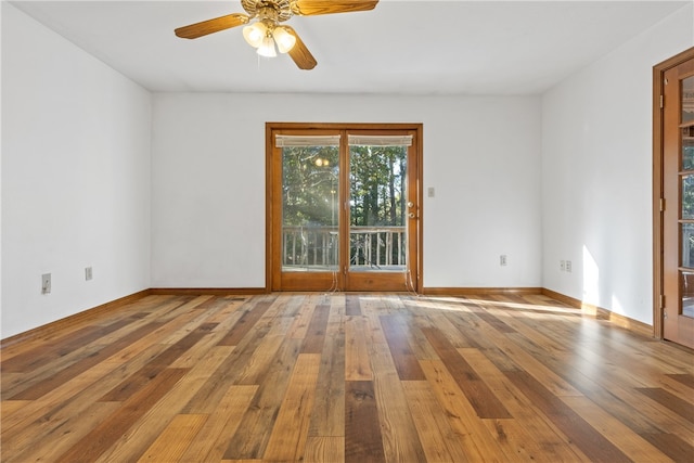 spare room featuring wood-type flooring and ceiling fan