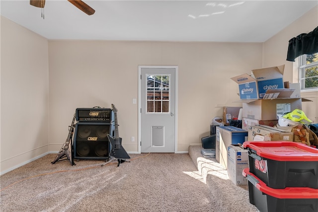 misc room with carpet floors and ceiling fan