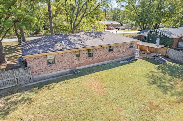 exterior space with a lawn and central air condition unit