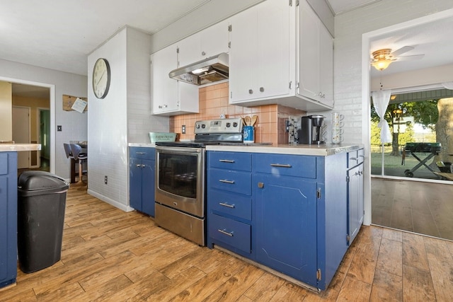 kitchen featuring electric stove, light hardwood / wood-style floors, white cabinetry, and range hood