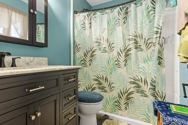 bathroom with walk in shower, vanity, and toilet