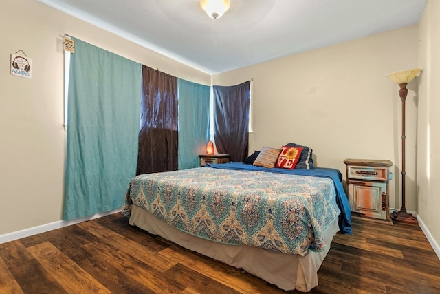 bedroom with dark wood-type flooring