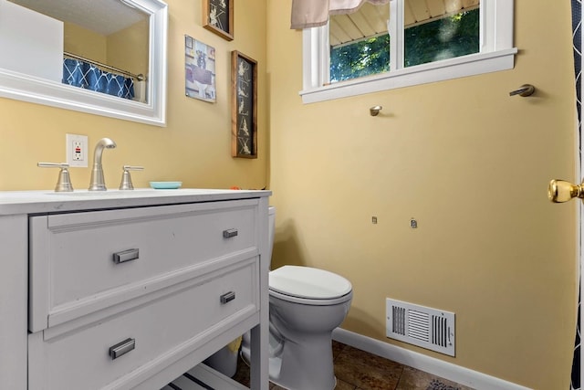 bathroom featuring vanity, toilet, and tile patterned floors