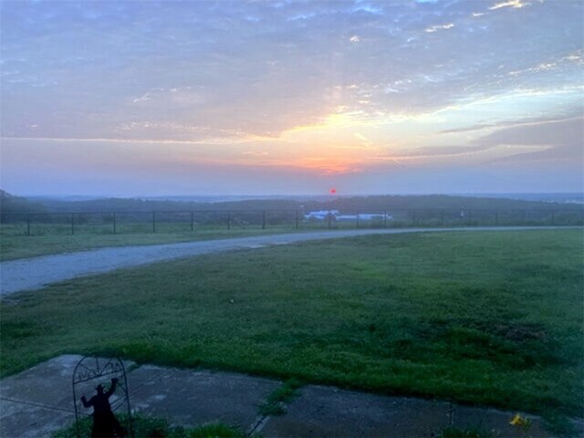 yard at dusk with a rural view