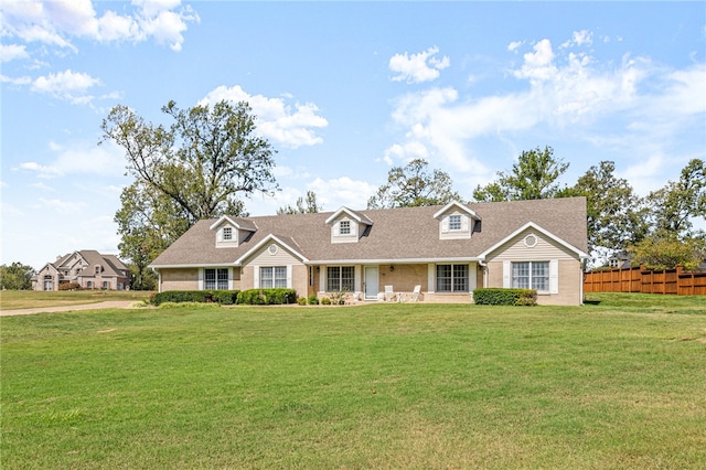 new england style home with a front lawn