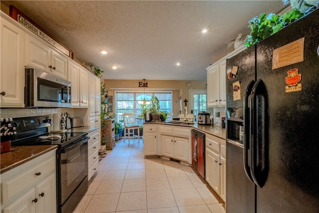 kitchen with white cabinets, kitchen peninsula, and black appliances