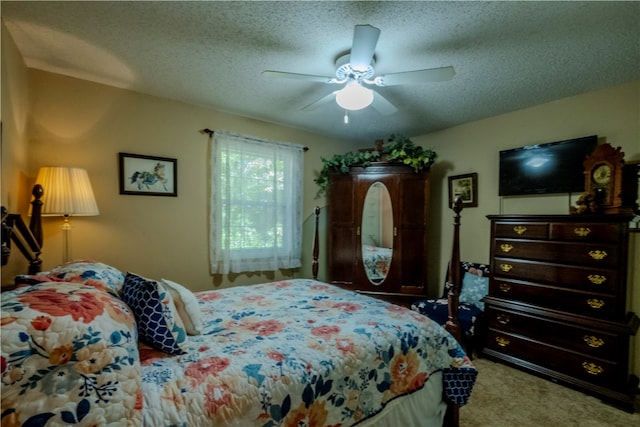 carpeted bedroom featuring a textured ceiling and ceiling fan