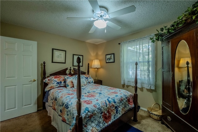 carpeted bedroom featuring ceiling fan and a textured ceiling