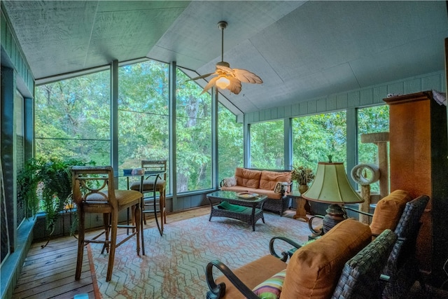 sunroom / solarium featuring ceiling fan, a healthy amount of sunlight, and lofted ceiling