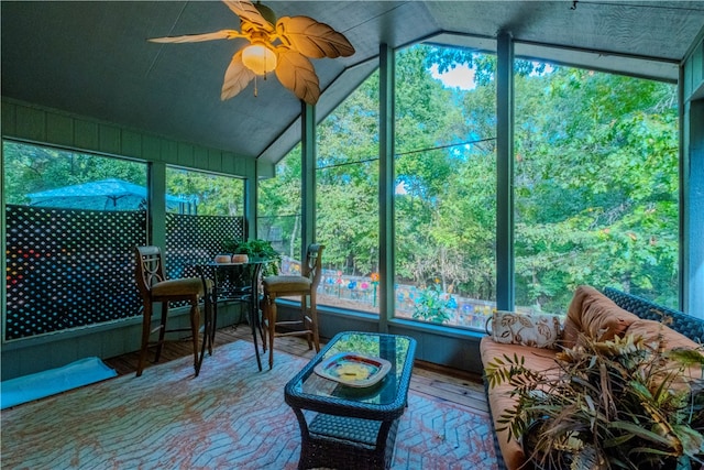 sunroom / solarium with ceiling fan and lofted ceiling