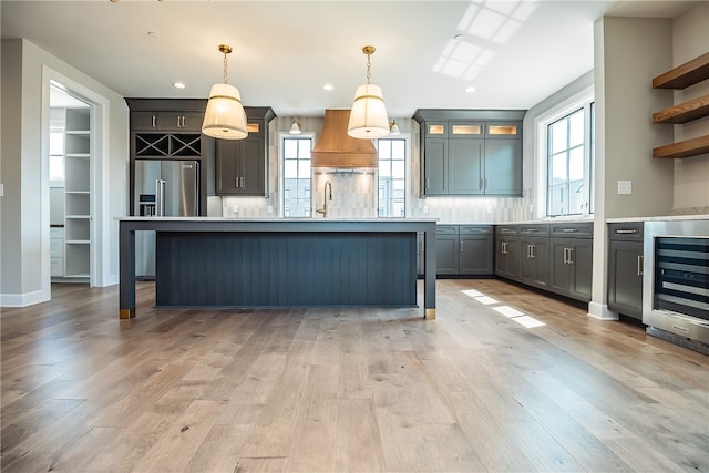 kitchen with pendant lighting, plenty of natural light, and light hardwood / wood-style floors