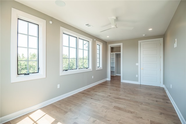 unfurnished bedroom featuring ceiling fan, a closet, and light hardwood / wood-style floors