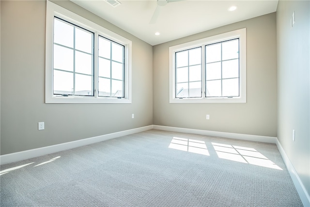 spare room with light carpet and ceiling fan